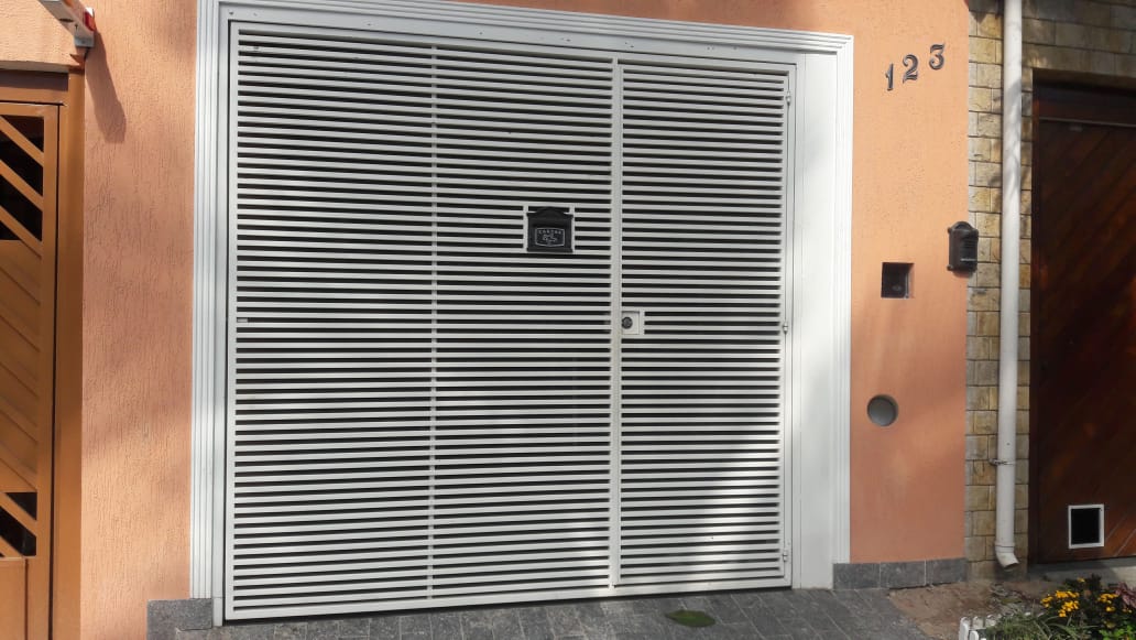 Portão branco de lambril instalado em residência